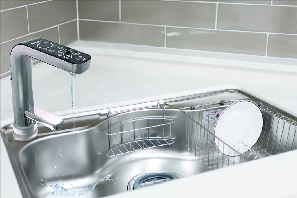 Water for Life Rio alkaline water ionizer digital faucet dispensing water into a stainless steel kitchen sink.